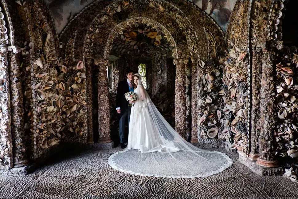 Bride and groom posing for photo in the Shell Grotto